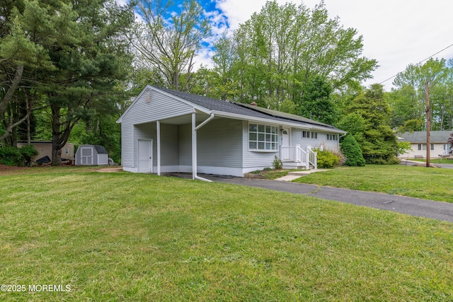 ranch-style home with a front lawn, a carport, and asphalt driveway