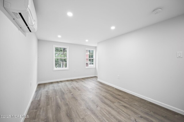47 Imlaystown Rd, Cream Ridge, NJ 08514 - spare room with a wall mounted AC, wood finished floors, a smoke detector, recessed lighting, and baseboards