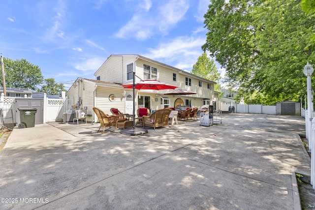 15 Creighton Cir, Old Bridge, NJ 08857 - rear view of property featuring a patio area, outdoor lounge area, and central AC unit