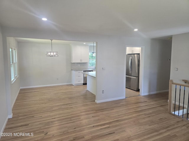 330 Broad St, Eatontown, NJ 07724 - unfurnished living room with light wood-type flooring, baseboards, recessed lighting, and a chandelier