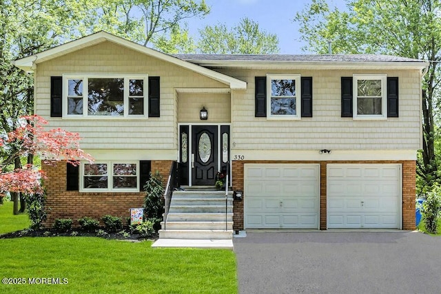 330 Broad St, Eatontown, NJ 07724 - raised ranch with asphalt driveway, an attached garage, a front yard, brick siding, and a shingled roof