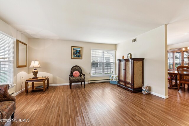 27 Gladstone Ave, Manchester, NJ 08759 - living area with a baseboard radiator, wood finished floors, and baseboards