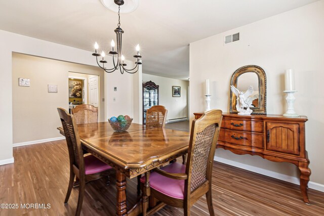 27 Gladstone Ave, Manchester, NJ 08759 - dining area with a chandelier, wood finished floors, baseboards, and a baseboard heating unit