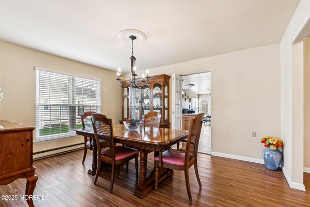 27 Gladstone Ave, Manchester, NJ 08759 - dining space with baseboard heating, a chandelier, wood finished floors, and baseboards