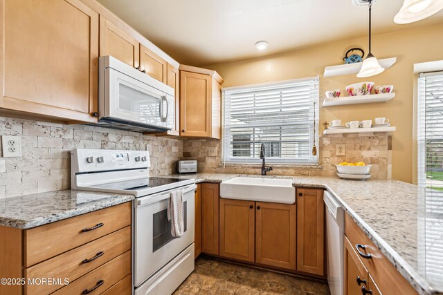 27 Gladstone Ave, Manchester, NJ 08759 - kitchen featuring white appliances, a sink, backsplash, light stone countertops, and pendant lighting