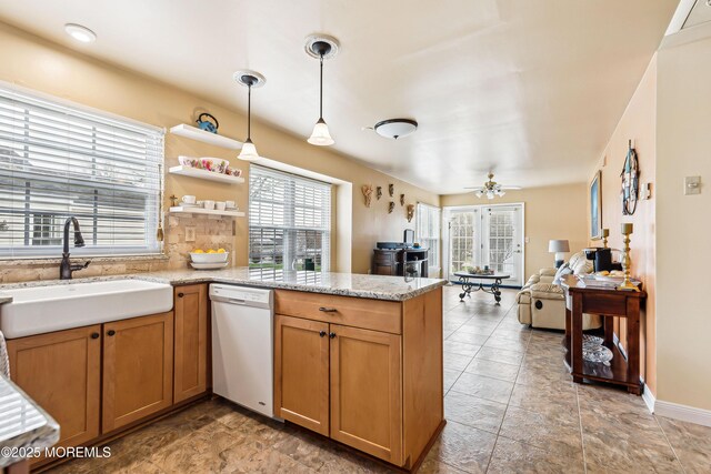 27 Gladstone Ave, Manchester, NJ 08759 - kitchen with white dishwasher, a sink, a peninsula, pendant lighting, and open floor plan