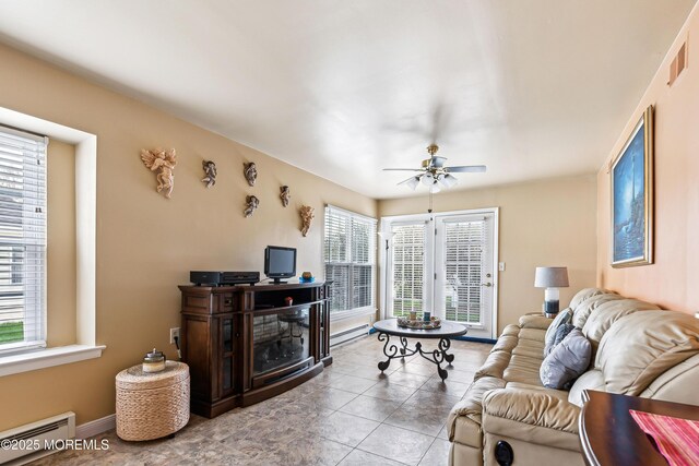 27 Gladstone Ave, Manchester, NJ 08759 - tiled living room with baseboard heating, ceiling fan, and baseboards