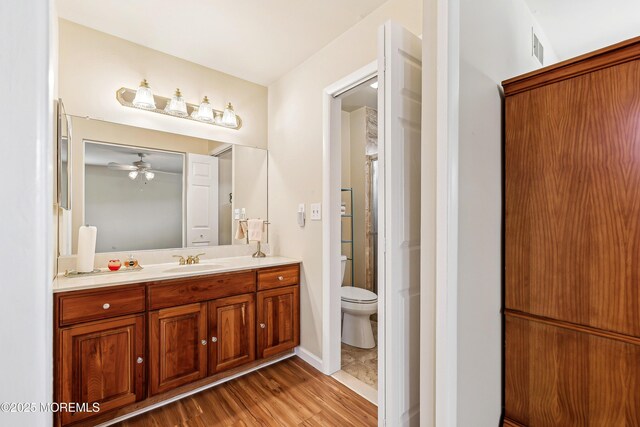 27 Gladstone Ave, Manchester, NJ 08759 - bathroom featuring vanity, toilet, wood finished floors, and a ceiling fan