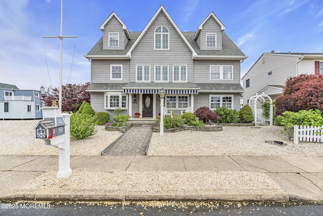view of front of house with a shingled roof