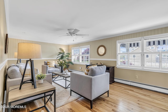 living room with baseboard heating, crown molding, a ceiling fan, wood finished floors, and a baseboard radiator