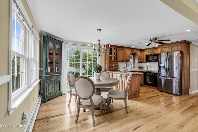 dining room with light wood-style floors, a chandelier, ceiling fan, baseboard heating, and recessed lighting