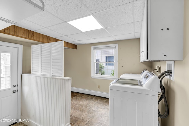 clothes washing area featuring baseboards, cabinet space, independent washer and dryer, and a baseboard radiator