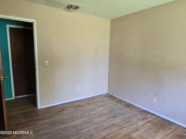empty room with wood finished floors and baseboards