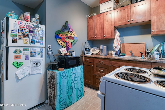 kitchen with white appliances, a sink, and brown cabinets