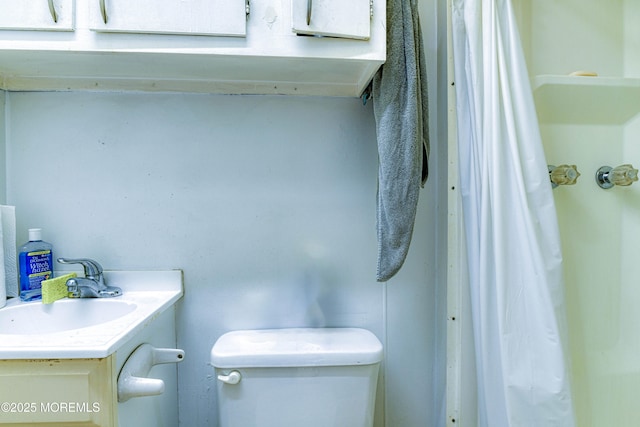 bathroom featuring toilet and vanity