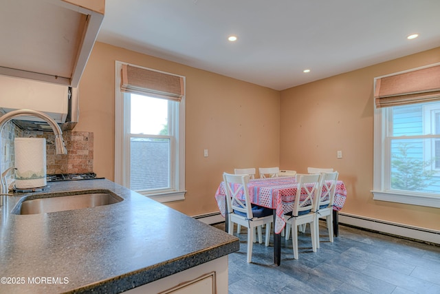 dining area with healthy amount of natural light, recessed lighting, and a baseboard heating unit