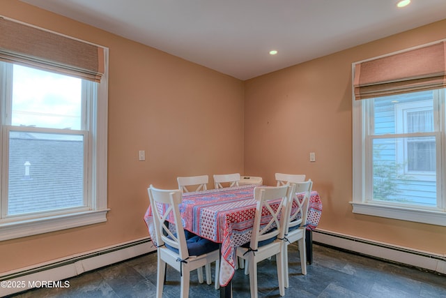 dining room with baseboard heating, healthy amount of natural light, recessed lighting, and stone finish flooring