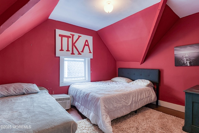 bedroom featuring vaulted ceiling, wood finished floors, and baseboards