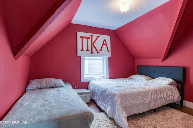 bedroom with wood finished floors and vaulted ceiling