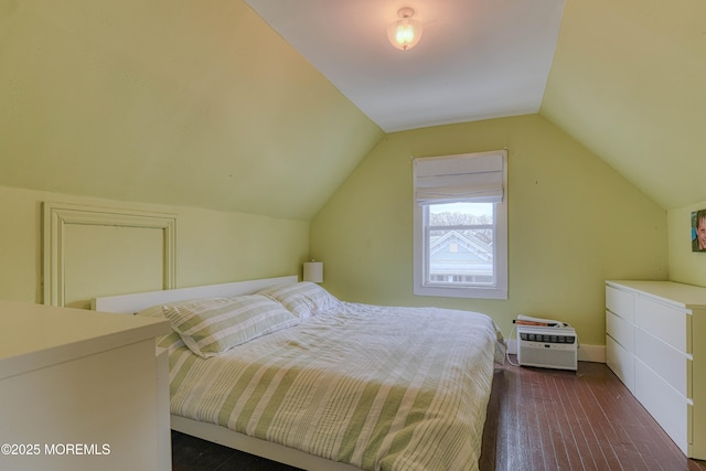 bedroom featuring dark wood-type flooring, vaulted ceiling, and baseboards