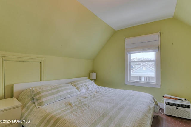 bedroom with vaulted ceiling, dark wood-style floors, and baseboards
