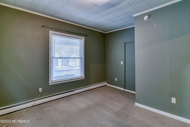 carpeted empty room with baseboard heating, crown molding, a smoke detector, and baseboards