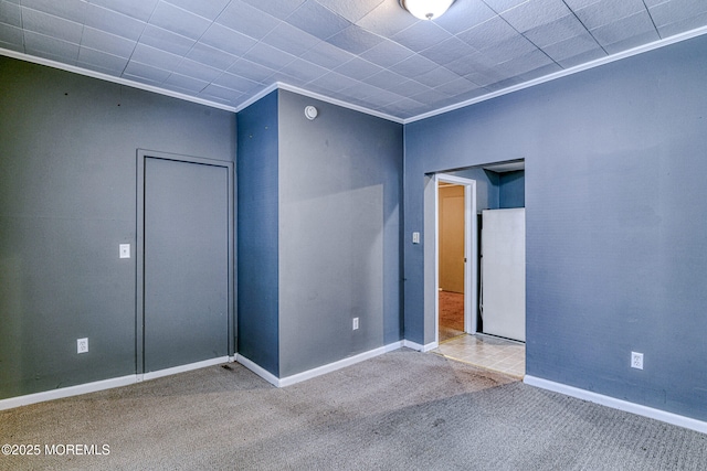 unfurnished room with carpet floors, baseboards, and ornamental molding