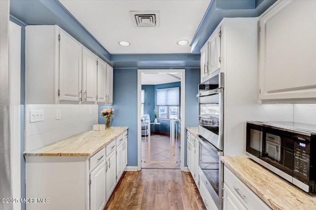 55 Yorktowne Dr, Manalapan, NJ 07726 - kitchen featuring double oven, white cabinets, baseboards, light wood finished floors, and recessed lighting