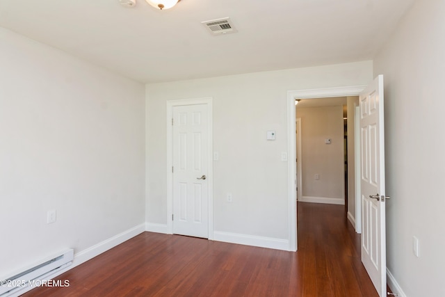 7 Danbury Ct, Red Bank, NJ 07701 - unfurnished bedroom with a baseboard heating unit and wood finished floors