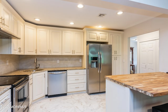 7 Danbury Ct, Red Bank, NJ 07701 - kitchen with stainless steel appliances, light marble finish floors, wood counters, backsplash, and recessed lighting