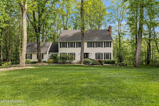 112 Deer Path Ln, Freehold, NJ 07728 - colonial house featuring a chimney and a front yard