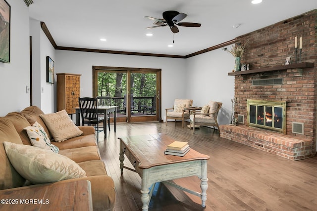 112 Deer Path Ln, Freehold, NJ 07728 - living room featuring ornamental molding, wood finished floors, a ceiling fan, a brick fireplace, and recessed lighting
