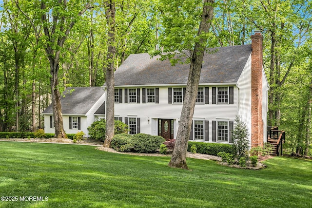 112 Deer Path Ln, Freehold, NJ 07728 - colonial inspired home with a front lawn, a chimney, a shingled roof, and stairway