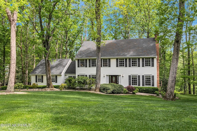 112 Deer Path Ln, Freehold, NJ 07728 - colonial-style house featuring a front yard, a chimney, and roof with shingles
