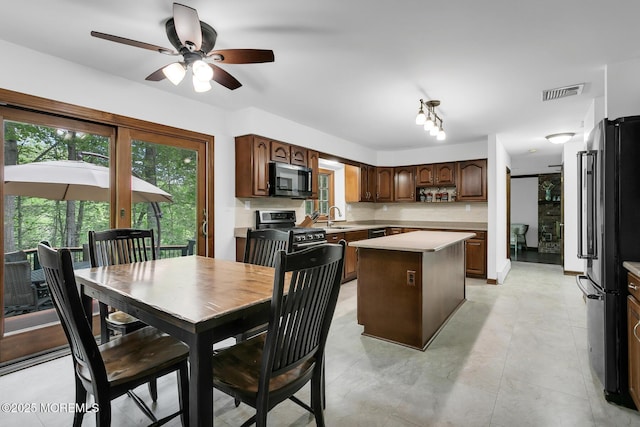 112 Deer Path Ln, Freehold, NJ 07728 - kitchen featuring gas stove, freestanding refrigerator, a center island, light countertops, and a ceiling fan