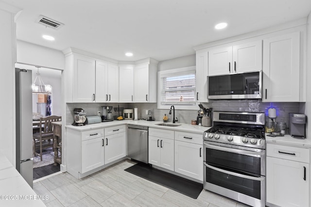 639 Longview Dr, Toms River, NJ 08753 - kitchen featuring appliances with stainless steel finishes, a sink, decorative backsplash, white cabinets, and recessed lighting