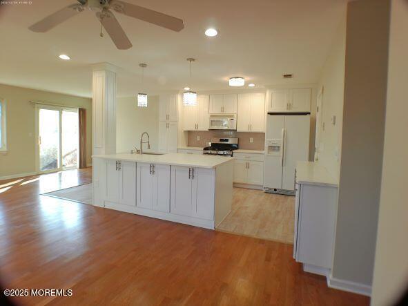 28 Bayview Ct, Long Branch, NJ 07740 - kitchen with white appliances, a sink, light wood-style flooring, light countertops, and ceiling fan
