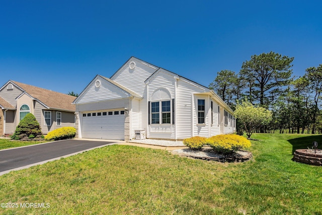 14 Winterton Dr, Toms River, NJ 08757 - ranch-style home featuring asphalt driveway, an attached garage, and a front yard