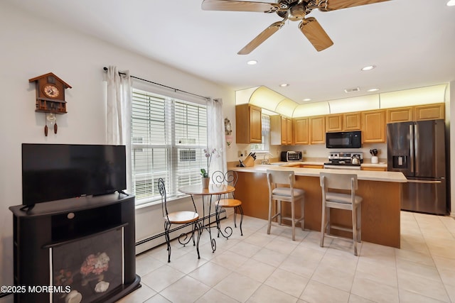 14 Winterton Dr, Toms River, NJ 08757 - kitchen featuring stainless steel appliances, light countertops, a sink, baseboard heating, and a peninsula