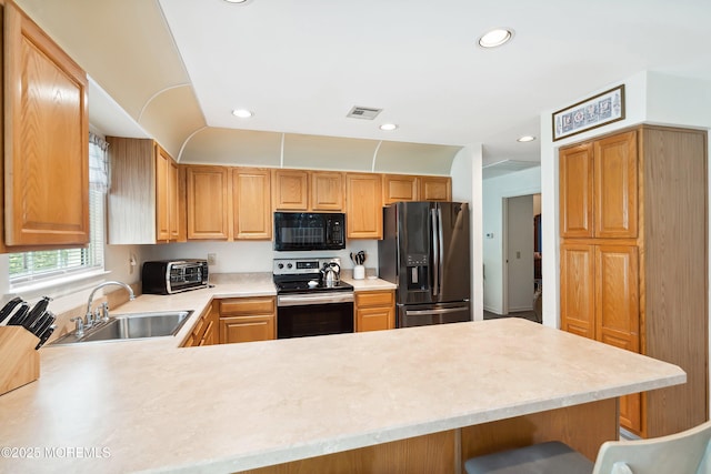 14 Winterton Dr, Toms River, NJ 08757 - kitchen with black appliances, a sink, light countertops, a peninsula, and recessed lighting