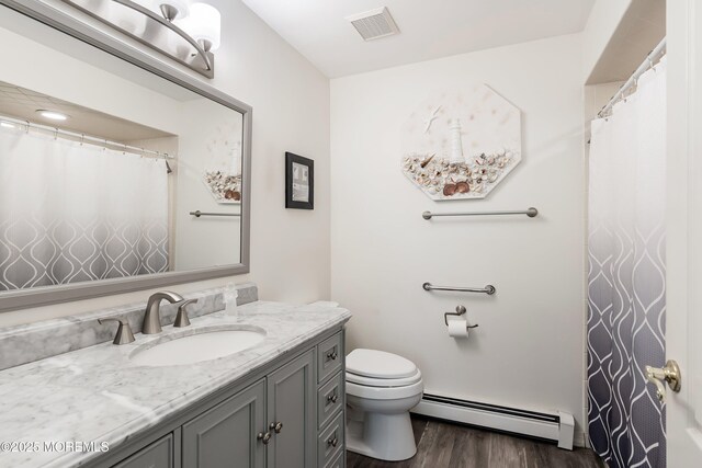 14 Winterton Dr, Toms River, NJ 08757 - bathroom with a baseboard radiator, wood finished floors, toilet, and vanity