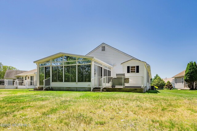14 Winterton Dr, Toms River, NJ 08757 - back of property featuring a sunroom, a yard, and a wooden deck