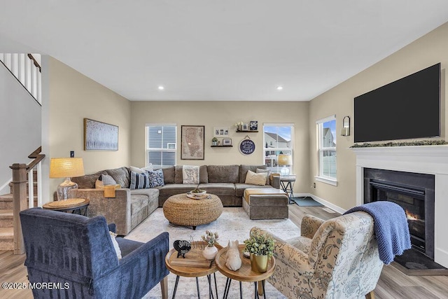 83 Weston Dr, Woolwich, NJ 08085 - living room featuring stairway, a glass covered fireplace, baseboards, wood finished floors, and recessed lighting