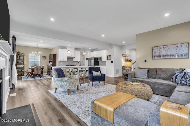 83 Weston Dr, Woolwich, NJ 08085 - living area featuring dark wood-style flooring, a chandelier, recessed lighting, and baseboards