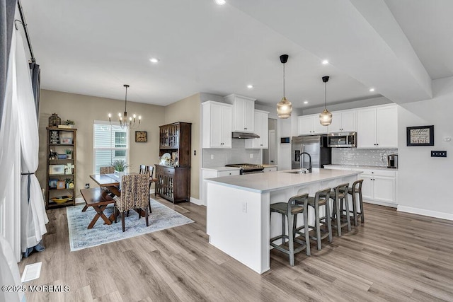 83 Weston Dr, Woolwich, NJ 08085 - kitchen with stainless steel appliances, light wood finished floors, decorative backsplash, light countertops, and recessed lighting