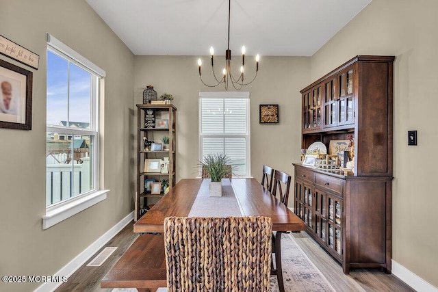 83 Weston Dr, Woolwich, NJ 08085 - dining space with a chandelier, wood finished floors, and plenty of natural light