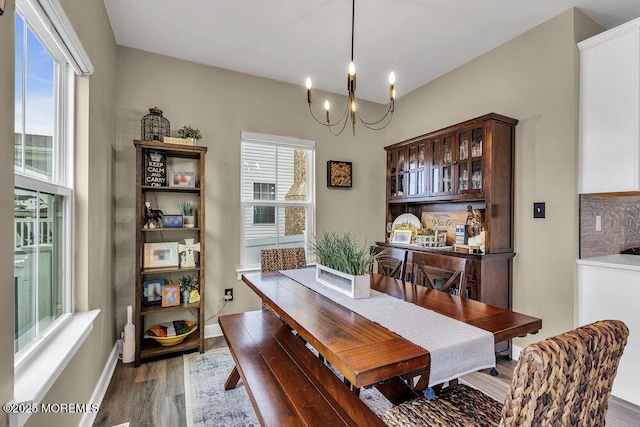 83 Weston Dr, Woolwich, NJ 08085 - dining room featuring a chandelier, wood finished floors, and baseboards
