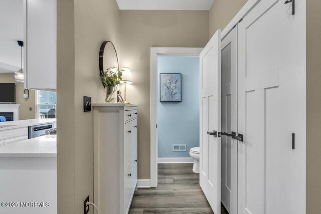 83 Weston Dr, Woolwich, NJ 08085 - hallway featuring dark wood-style flooring and baseboards