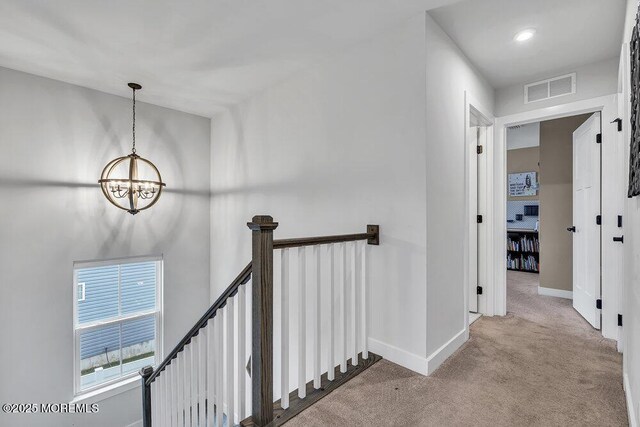 83 Weston Dr, Woolwich, NJ 08085 - hall featuring a chandelier, carpet, an upstairs landing, and baseboards