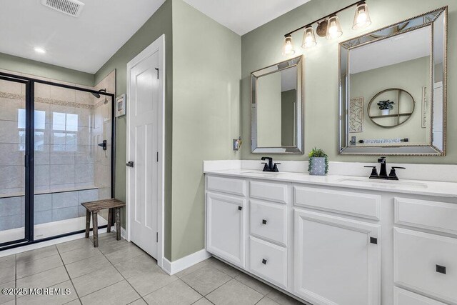 83 Weston Dr, Woolwich, NJ 08085 - bathroom with tile patterned floors, tiled shower, double vanity, and baseboards